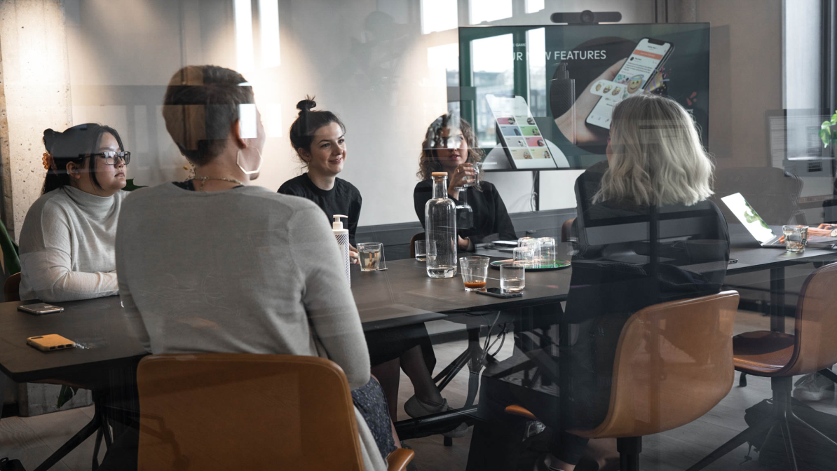 Image of a group of people sitting around a table and chatting